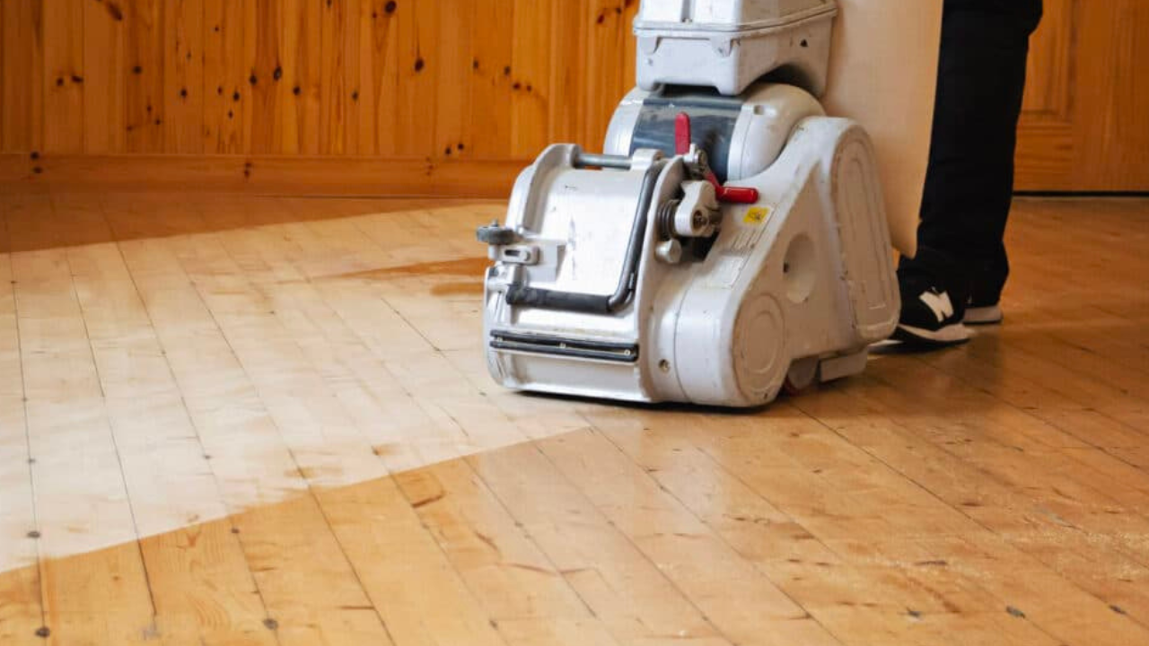 Wood Floor Sanding in Harrow on pine softwood floorboards, with a professional dust-free sanding machine stripping the old finish.